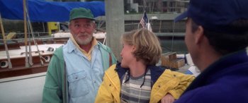 Movie still from “Multiplicity” (1996), directed by Harold Ramis – A man standing next to a boy in a yellow jacket; Medium shot, High angle