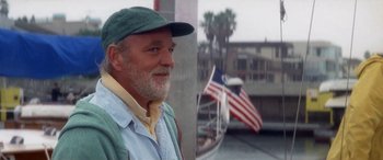 Movie still from “Multiplicity” (1996), directed by Harold Ramis – An older man wearing a hat standing in front of a boat; Close Up shot, Low angle