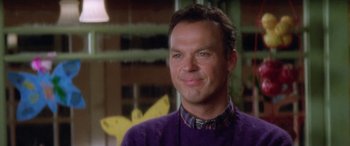 Movie still from “Multiplicity” (1996), directed by Harold Ramis – A person wearing a purple sweater; Close Up shot, Over the shoulder angle