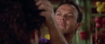 Movie still from “Multiplicity” (1996), directed by Harold Ramis – A person brushing their hair; Close Up shot, Over the shoulder angle