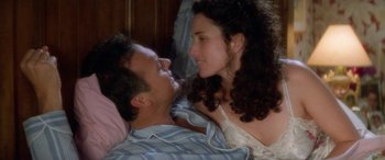 Movie still from “Multiplicity” (1996), directed by Harold Ramis – A man and a woman laying in bed together; Close Up shot, Overhead angle