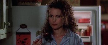 Movie still from “Multiplicity” (1996), directed by Harold Ramis – A person with curly hair holding a spoon; Close Up shot, Over the shoulder angle