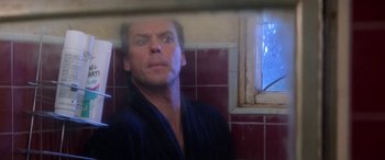 Movie still from “Multiplicity” (1996), directed by Harold Ramis – A man in a black robe looking out of a window; Close Up shot, Low angle