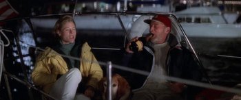 Movie still from “Multiplicity” (1996), directed by Harold Ramis – A man and a woman sitting in a boat with a dog and a beer; Medium shot, Low angle
