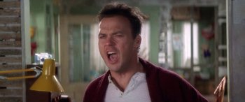 Movie still from “Multiplicity” (1996), directed by Harold Ramis – A man in a white shirt and a red sweater is yelling; Close Up shot, Low angle