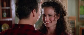 Movie still from “Multiplicity” (1996), directed by Harold Ramis – A man and a woman smiling at each other; Close Up shot, Over the shoulder angle