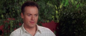 Movie still from “Multiplicity” (1996), directed by Harold Ramis – A person wearing a plaid shirt; Close Up shot, Over the shoulder angle