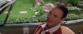 Movie still from “Multiplicity” (1996), directed by Harold Ramis – A man sitting in the back seat of a car; Close Up shot, Over the shoulder angle