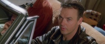 Movie still from “Multiplicity” (1996), directed by Harold Ramis – A person wearing a leather jacket; Close Up shot, Over the shoulder angle