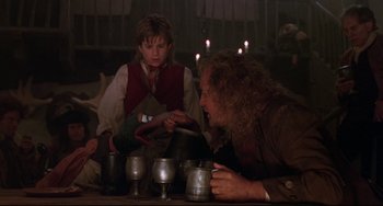 Movie still from “Muppet Treasure Island” (1996), directed by David Lane – A man and a woman sitting at a table with cups; Medium shot, Over the shoulder angle