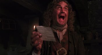 Movie still from “Muppet Treasure Island” (1996), directed by David Lane – A man with curly hair holding a piece of paper; Close Up shot, Low angle