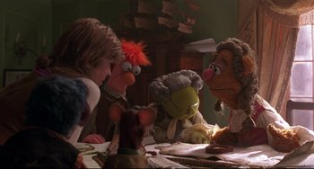 Movie still from “Muppet Treasure Island” (1996), directed by David Lane – A group of people sitting at a table with puppets; Medium shot, Over the shoulder angle