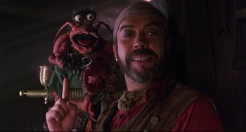 Movie still from “Muppet Treasure Island” (1996), directed by David Lane – A man with a beard and a pirate costume and a puppet; Close Up shot, Over the shoulder angle