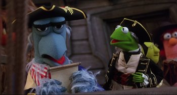 Movie still from “Muppet Treasure Island” (1996), directed by David Lane – A couple of muppets are sitting next to each other; Medium shot, Low angle