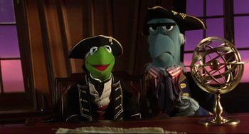 Movie still from “Muppet Treasure Island” (1996), directed by David Lane – A couple of stuffed animals sitting next to each other on a table; Medium shot, Low angle