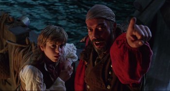 Movie still from “Muppet Treasure Island” (1996), directed by David Lane – A man and a boy are standing next to each other; Medium shot, Over the shoulder angle