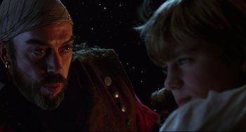 Movie still from “Muppet Treasure Island” (1996), directed by David Lane – A man and a boy are looking at each other in the dark; Close Up shot, Over the shoulder angle