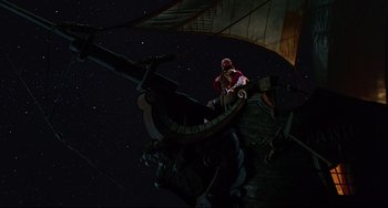 Movie still from “Muppet Treasure Island” (1996), directed by David Lane – A man sitting on top of a boat at night; Wide shot, Overhead angle