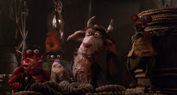 Movie still from “Muppet Treasure Island” (1996), directed by David Lane – A group of stuffed animals sitting next to each other on a rope; Medium shot, Low angle