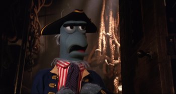 Movie still from “Muppet Treasure Island” (1996), directed by David Lane – The head of a character in a pirate costume; Close Up shot, Low angle