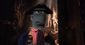 Movie still from “Muppet Treasure Island” (1996), directed by David Lane – A person in a pirate costume holding a neck tie; Close Up shot, Low angle