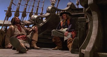 Movie still from “Muppet Treasure Island” (1996), directed by David Lane – Two people sitting on a boat in the middle of the day; Wide shot, Low angle