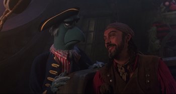 Movie still from “Muppet Treasure Island” (1996), directed by David Lane – A man in a pirate costume and a puppet; Medium shot, Over the shoulder angle
