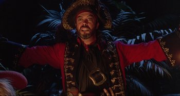 Movie still from “Muppet Treasure Island” (1996), directed by David Lane – A man wearing a pirate hat and a red jacket; Medium shot, Low angle