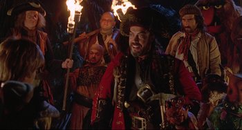 Movie still from “Muppet Treasure Island” (1996), directed by David Lane – A group of people dressed as pirates with torches; Medium shot, Low angle