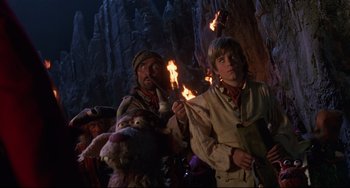 Movie still from “Muppet Treasure Island” (1996), directed by David Lane – A group of people standing next to each other holding torches; Medium shot, Low angle