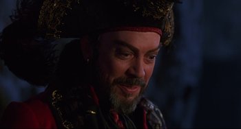 Movie still from “Muppet Treasure Island” (1996), directed by David Lane – A person with a beard wearing a hat; Close Up shot, Over the shoulder angle