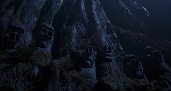 Movie still from “Muppet Treasure Island” (1996), directed by David Lane – A group of faces carved into the side of a tree; Wide shot, Low angle