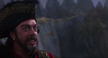 Movie still from “Muppet Treasure Island” (1996), directed by David Lane – A man with a beard wearing a red and black hat; Close Up shot, Low angle
