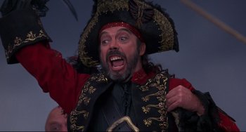 Movie still from “Muppet Treasure Island” (1996), directed by David Lane – A man wearing a pirate costume and a hat; Close Up shot, Low angle