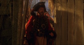 Movie still from “Muppet Treasure Island” (1996), directed by David Lane – A man dressed as a pirate is smoking a pipe; Medium shot, Low angle