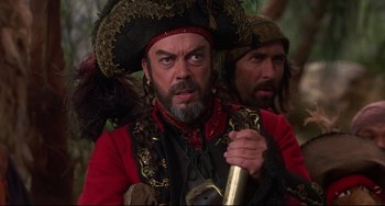Movie still from “Muppet Treasure Island” (1996), directed by David Lane – A man in a pirate costume holding a sword; Close Up shot, Over the shoulder angle