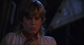 Movie still from “Muppet Treasure Island” (1996), directed by David Lane – A young man holding a knife in his hand; Close Up shot, High angle