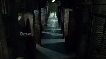 Movie still from “Muppets Most Wanted” (2014), directed by James Bobin – A hallway with many doors leading into a room; Wide shot, High angle