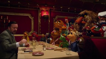 Movie still from “Muppets Most Wanted” (2014), directed by James Bobin – A group of stuffed animals sitting around a table; Wide shot, High angle
