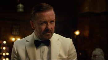 Movie still from “Muppets Most Wanted” (2014), directed by James Bobin – A person wearing a suit and bow tie; Close Up shot, Over the shoulder angle