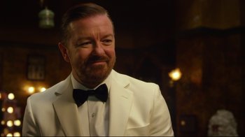 Movie still from “Muppets Most Wanted” (2014), directed by James Bobin – A person wearing a suit and bow tie; Close Up shot, Over the shoulder angle