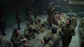 Movie still from “Muppets Most Wanted” (2014), directed by James Bobin – A group of men sitting around a table with pots and pans on it; Wide shot, Low angle