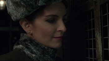 Movie still from “Muppets Most Wanted” (2014), directed by James Bobin – A person wearing a hat; Close Up shot, Over the shoulder angle