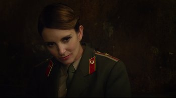 Movie still from “Muppets Most Wanted” (2014), directed by James Bobin – A woman in a military uniform is posing for a picture; Close Up shot, Over the shoulder angle
