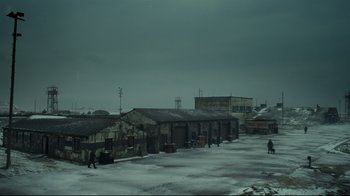 Movie still from “Muppets Most Wanted” (2014), directed by James Bobin – Two people walking on a snowy street near buildings; Extreme Wide shot, High angle
