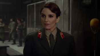 Movie still from “Muppets Most Wanted” (2014), directed by James Bobin – A woman in a military uniform is looking at the camera; Close Up shot, Over the shoulder angle