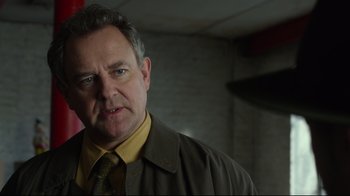 Movie still from “Muppets Most Wanted” (2014), directed by James Bobin – A person wearing a suit and tie; Close Up shot, Low angle