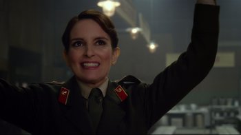 Movie still from “Muppets Most Wanted” (2014), directed by James Bobin – A woman in a military uniform waving at the camera; Close Up shot, Over the shoulder angle