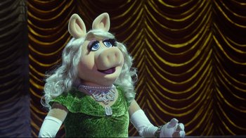 Movie still from “Muppets Most Wanted” (2014), directed by James Bobin – A woman dressed as miss piggy from the muppet show; Close Up shot, High angle