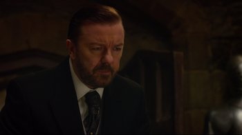 Movie still from “Muppets Most Wanted” (2014), directed by James Bobin – A person wearing a suit and tie; Close Up shot, Over the shoulder angle